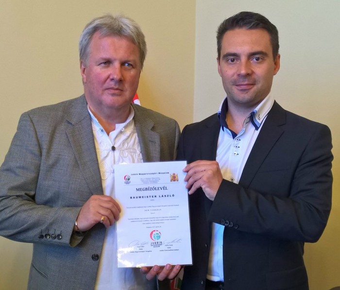 Mr. Baumeister (left) receives his accreditation from Jobbik Party Chairman Mr. Vona.