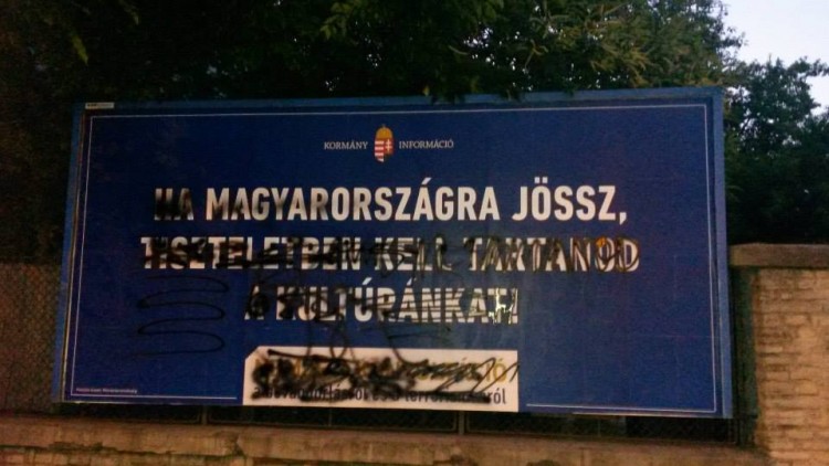 Another example of the Orbán government's defaced racist billboard. Here, they are telling immigrants that if they come to Hungary, they must abide by Hungarian laws.