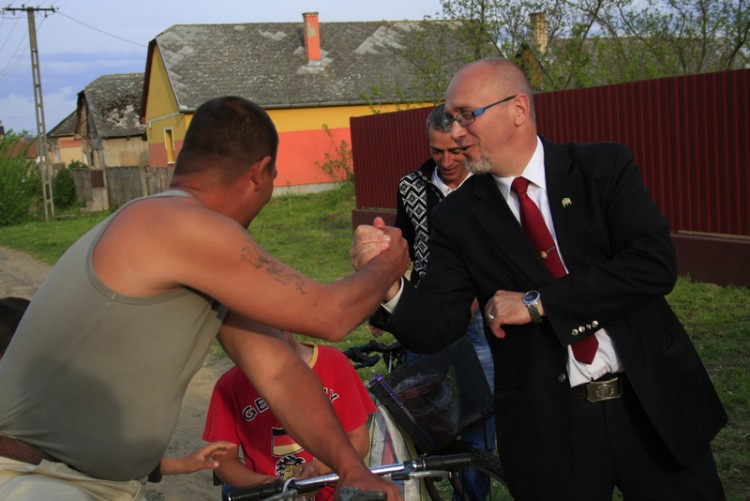 Mayor Orosz shares a friendly greeting and moment with local Roma. 