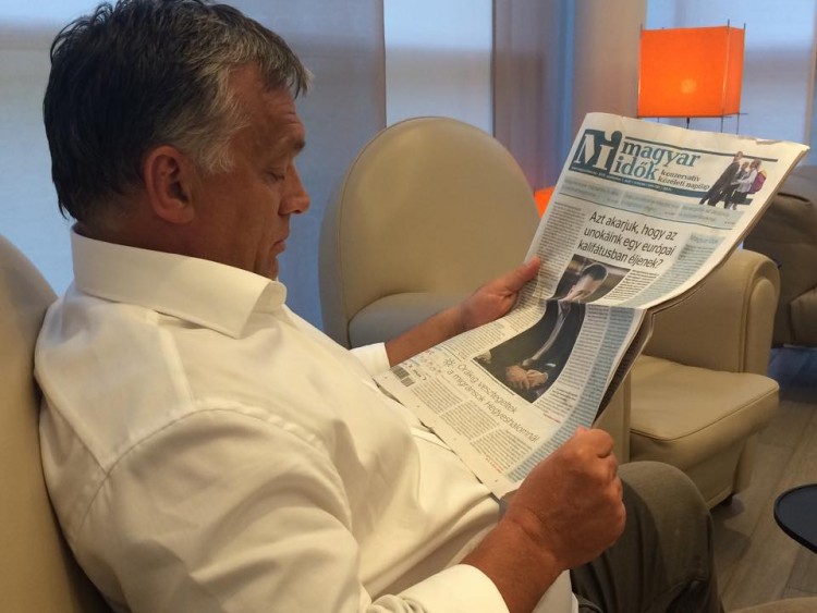 Mr. Orbán reads the cover page of the pro-government Magyar Idők daily, which features a headline warning readers about the risks of Hungary turning into an Islamic caliphate. 