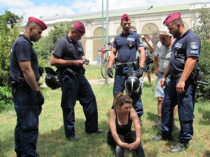 A demonstrator is removed by police. Photo: C. Adam