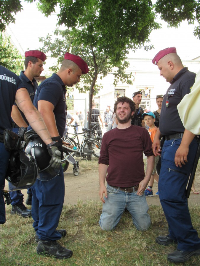 A demonstrator is taken down by police. Photo: C. Adam