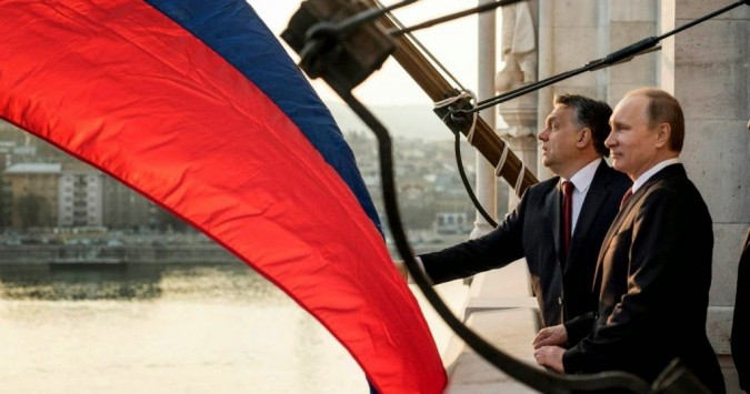 Vladimir Putin visits Viktor Orbán in Budapest, but the sizeable Russian flag blocks the view of the Hungarian capital. 