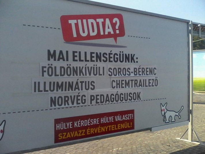 A Dog Party billboard, which reads: "Today's enemy: Extraterrestrial, Soros-hireling Illuminati Chemtrailing Norwegian teachers."