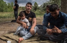 Dr.Yama Nayab, sits with his daughter in Szabadka (Hungarian-dominated northern Serbia), waiting to cross into Hungary. Dr. Nayab was a surgeon in Afghanistan. Photo: Sima Diab/The Guardian.