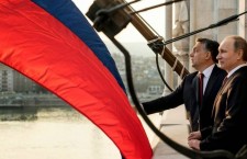 Vladimir Putin visits Viktor Orbán in Budapest, but the sizeable Russian flag blocks the view of the Hungarian capital.