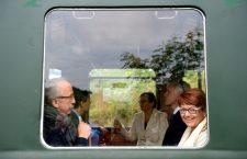 Ms. Grässle (right) smiles as she rides Mr. Orbán's vintage train.